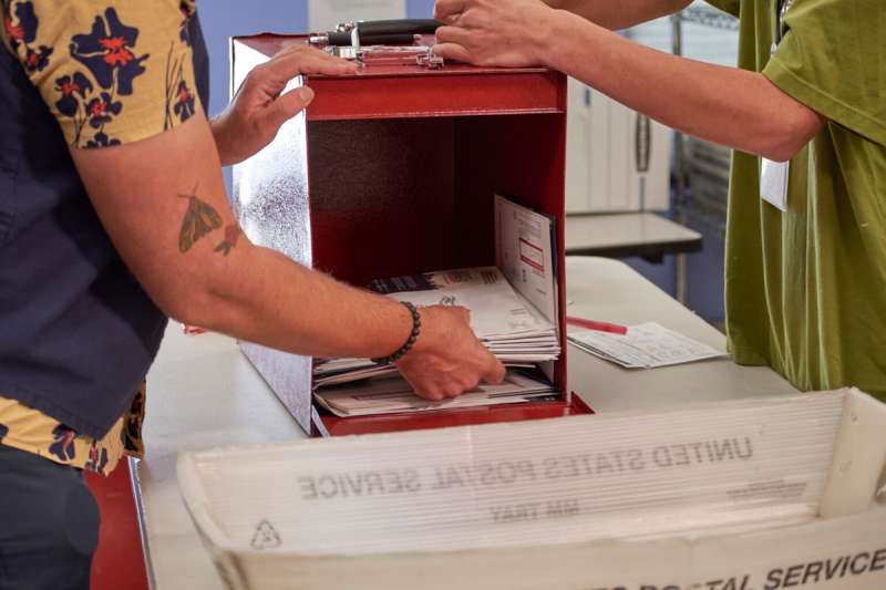 Volunteers at the Denver Clerk and Recorder’s office remove ballots from a ballot box. Jena Griswold is Colorado's top election official