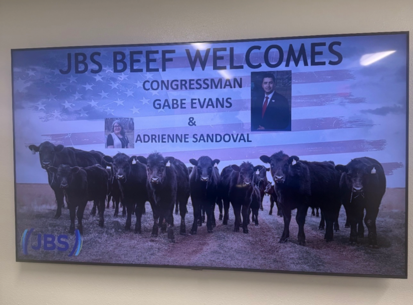 A screen in the lobby of the JBS meatpacking plant in Greeley, showing a welcome message for Evans and his aide. (Photo via Colorado Times Recorder; provided by UFCW7)