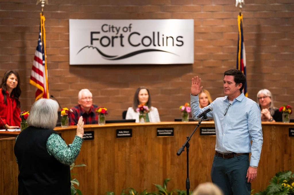 A man is sworn in to Fort Collins city council, which just approved a data center moratorium.